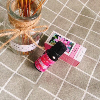 Bottle of FLIPSTYLEZLLC plant aromatherapy essential oil with a dropper cap on a wooden surface.