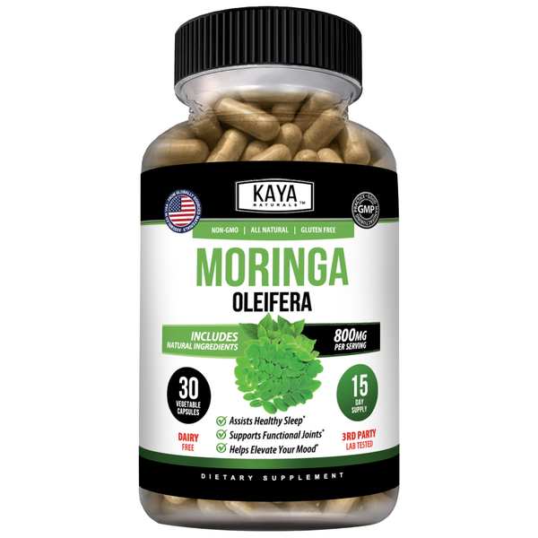 Moringa powder in a glass jar from Kaya Naturals, with fresh Moringa leaves and plant on a white background.
