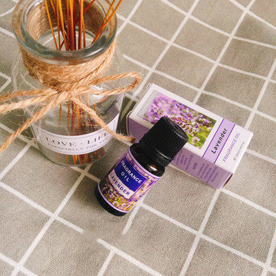 Bottle of FLIPSTYLEZLLC plant aromatherapy essential oil with a natural dropper and fresh herbs on a wooden surface.