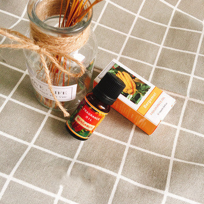 Bottle of FLIPSTYLEZLLC plant aromatherapy essential oil with fresh botanical leaves and a clear glass container.