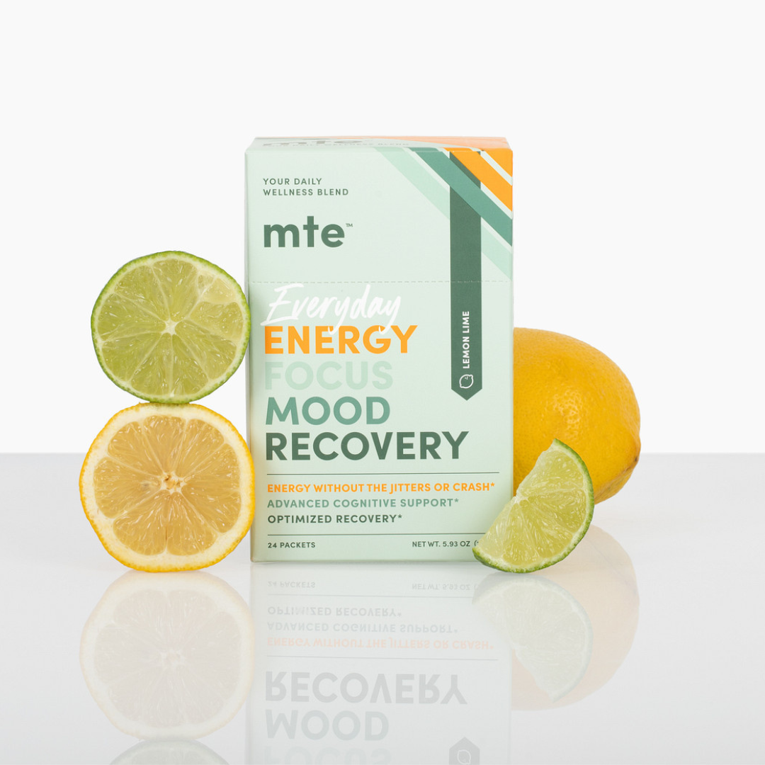 GetMTE More Than Energy powder in a scoop, showing the vibrant orange flavor packaging and the powdered supplement inside.