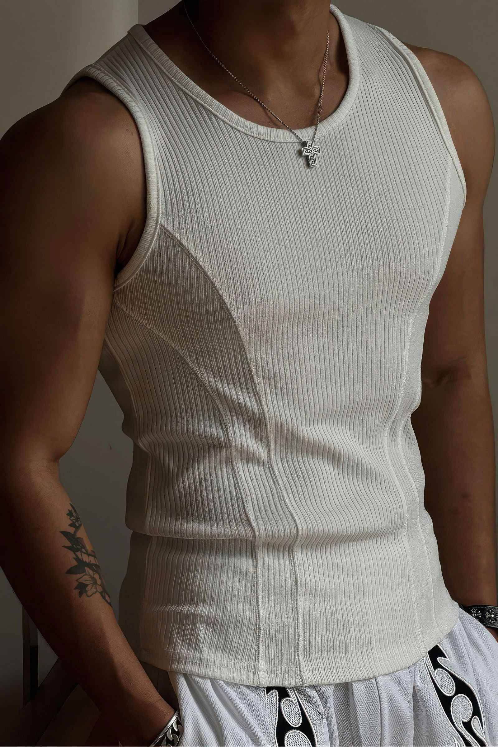 White athletic ribbed muscle tank top for men by 4inme, slim-fit sleeveless vest showing a close-up of the fabric and fit.