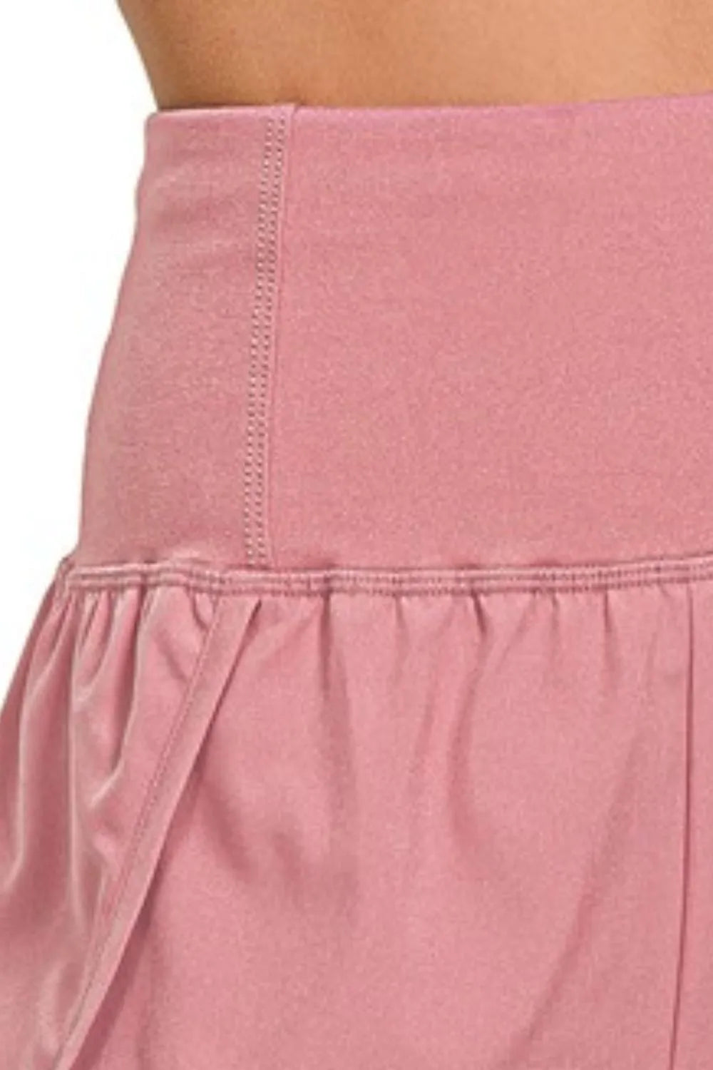 Berry Charmz Zenana high-waisted running shorts with zippered back pocket, showing a close-up of the black athletic shorts.