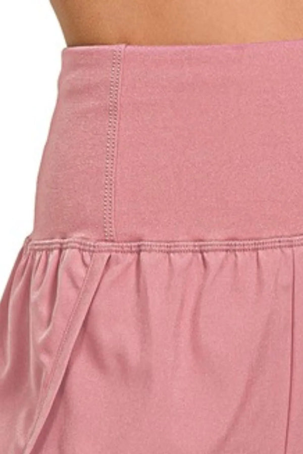 Berry Charmz Zenana high-waisted running shorts with zippered back pocket, showing a close-up of the black athletic shorts.