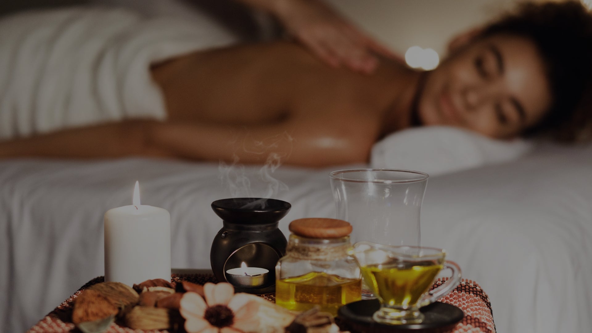 Calming aromatherapy essential oils diffuser candles with woman relaxing in spa