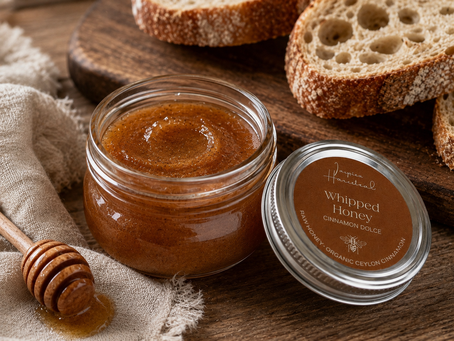 Open jar of Inspira Homestead Cinnamon Dolce Whipped Honey showing its creamy, cinnamon-infused honey texture and rich aroma.