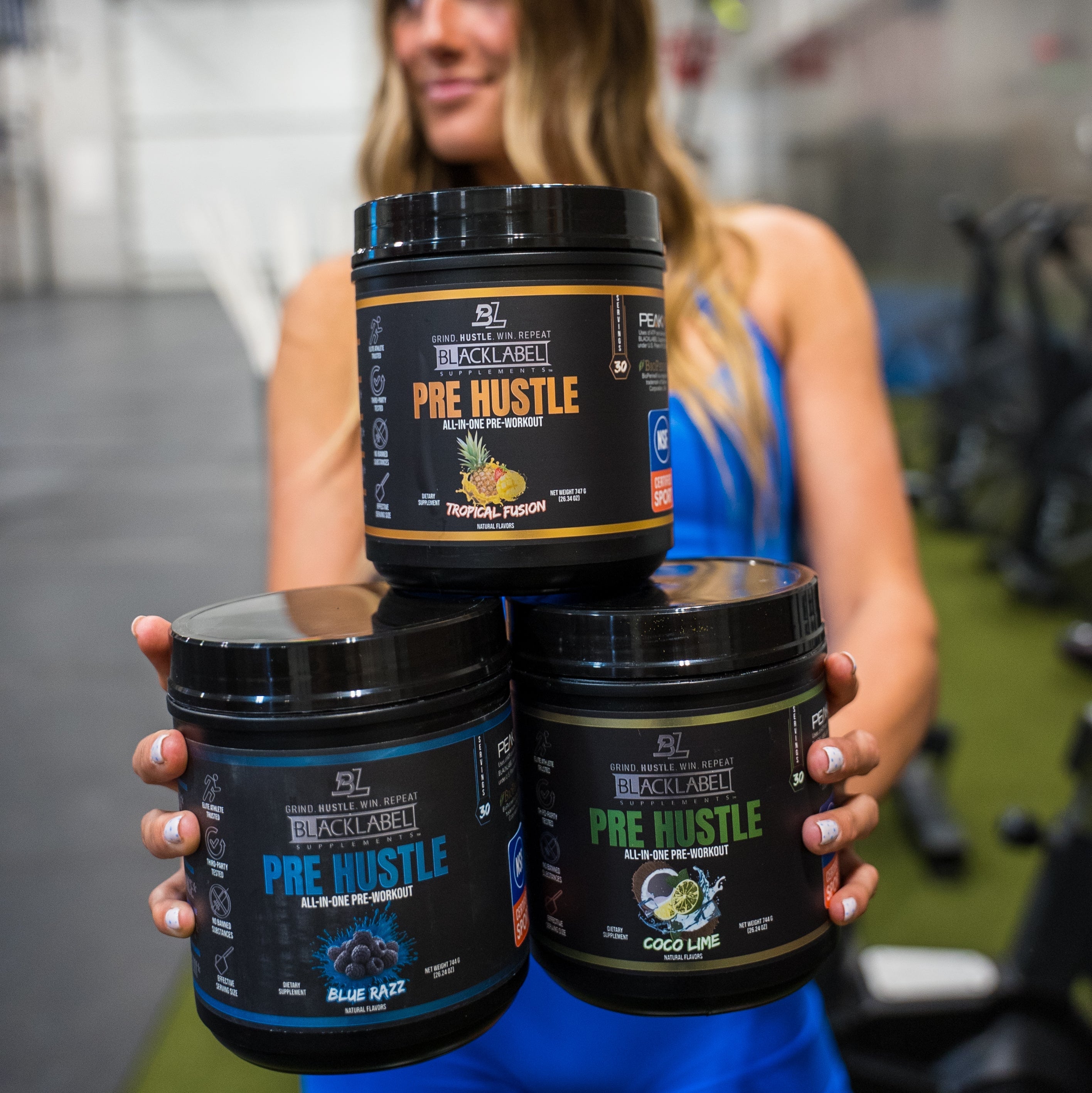 BlackLabel Supplements PRE HUSTLE V3 pre-workout powder in a bright container, with scoop and label visible.
