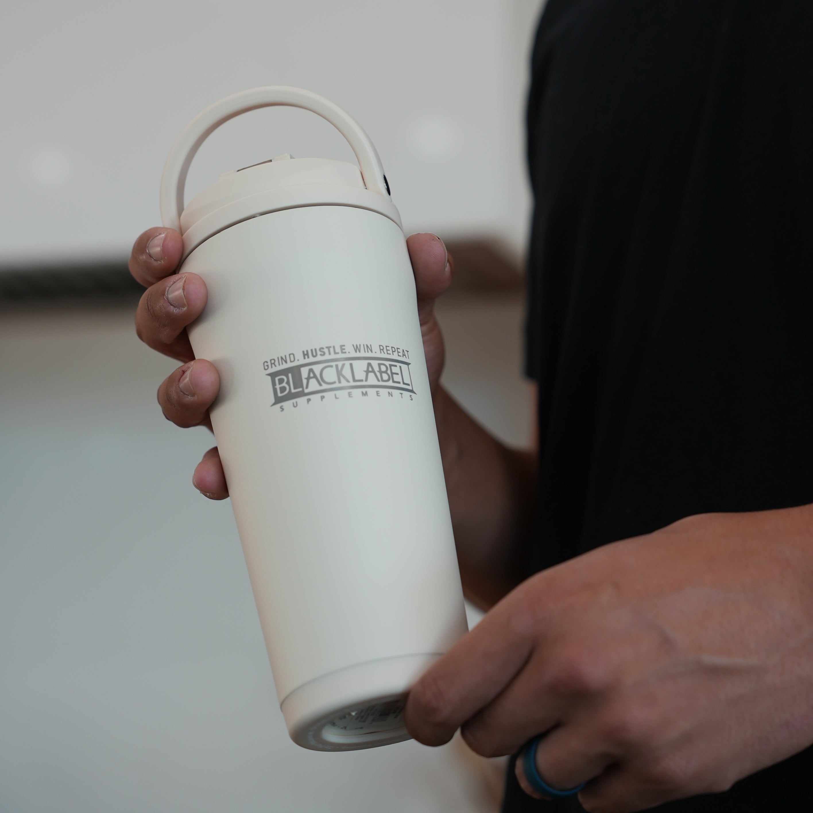 BlackLabel Supplements HydroJug 24 oz insulated shaker bottle with a secure lid and ergonomic handle, designed for cold drinks.
