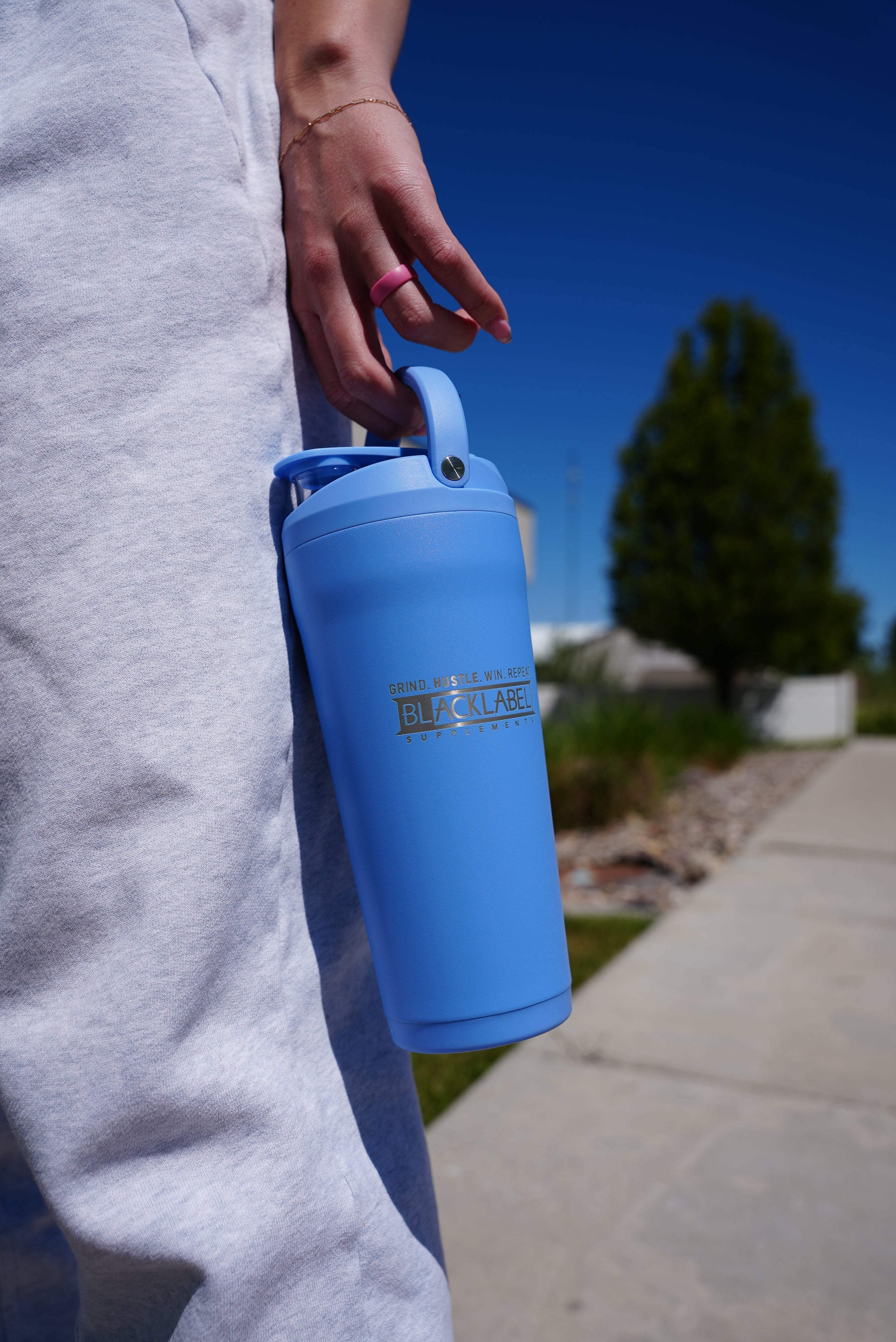 BlackLabel Supplements HydroJug 24 oz. insulated shaker with a secure lid and ergonomic design for hydration and workout use.