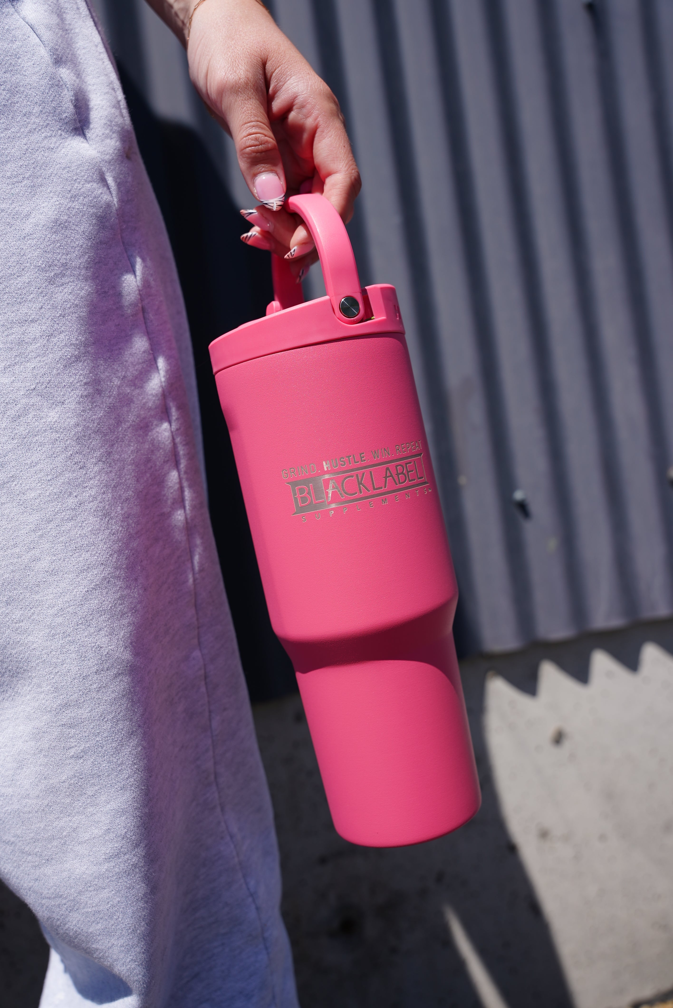 BlackLabel Supplements HydroJug 32 oz. sport cup with a flip-top lid and ergonomic handle for hydration during workouts.