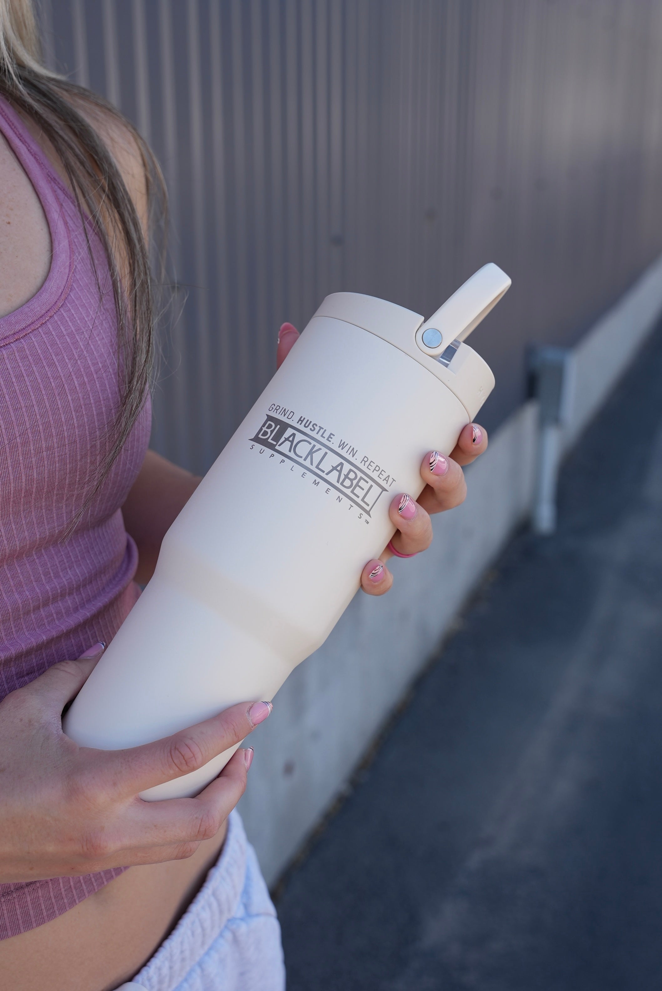 Black Label Supplements HydroJug 32 oz. sports water cup with ergonomic design and secure lid for active hydration.