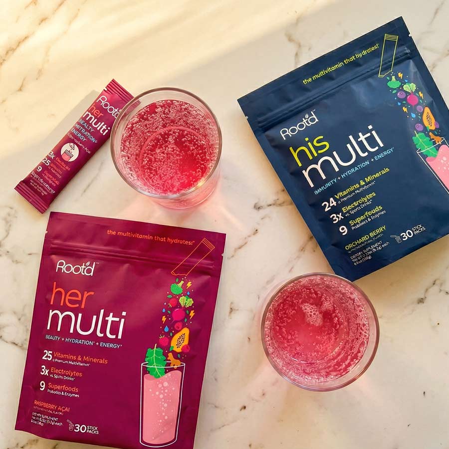 Couples' wellness pack featuring Root'd hydrating multivitamins for her and him, with two bottles of multivitamin supplements.