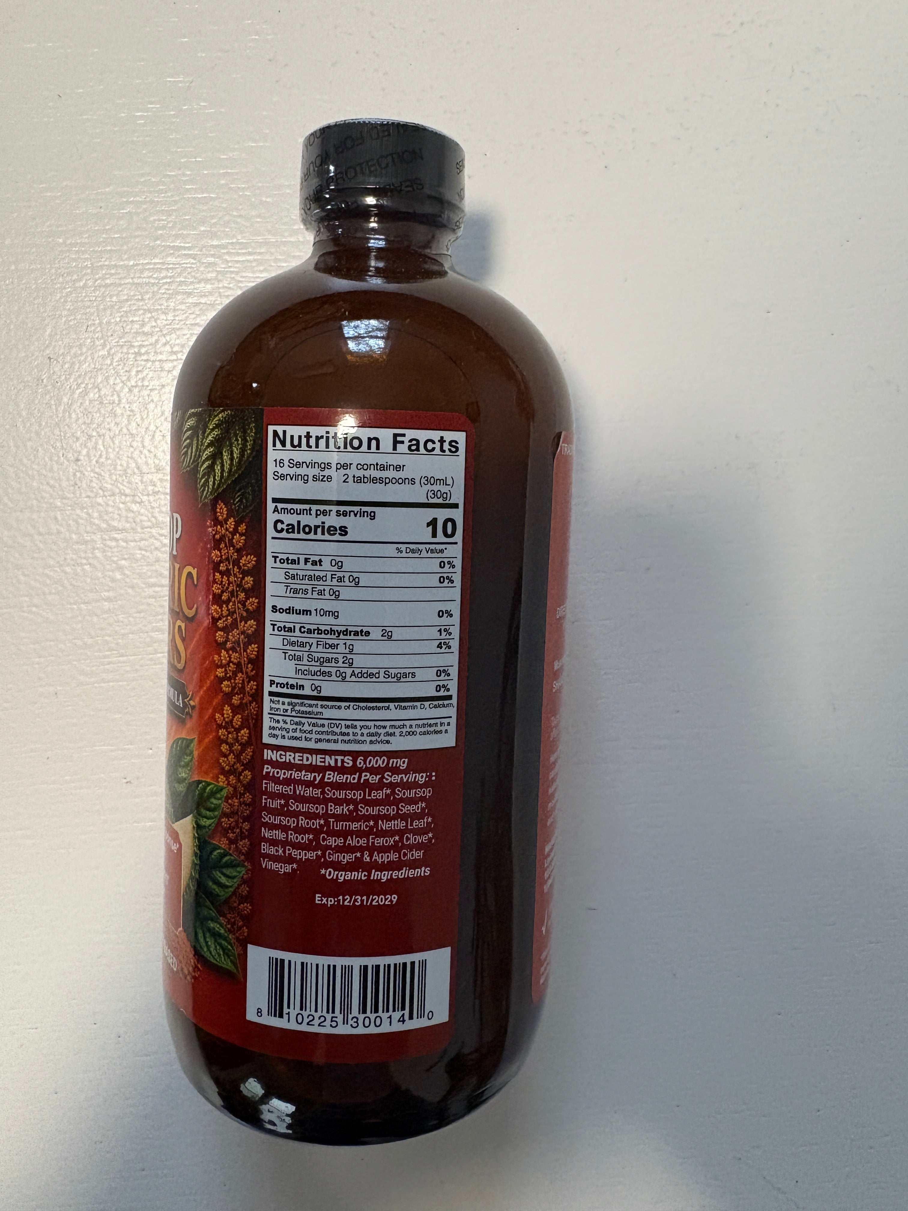 Vegan supplement bottle of VeggieVerve Organic Soursop Turmeric Bitters with fresh soursop and turmeric roots around it.