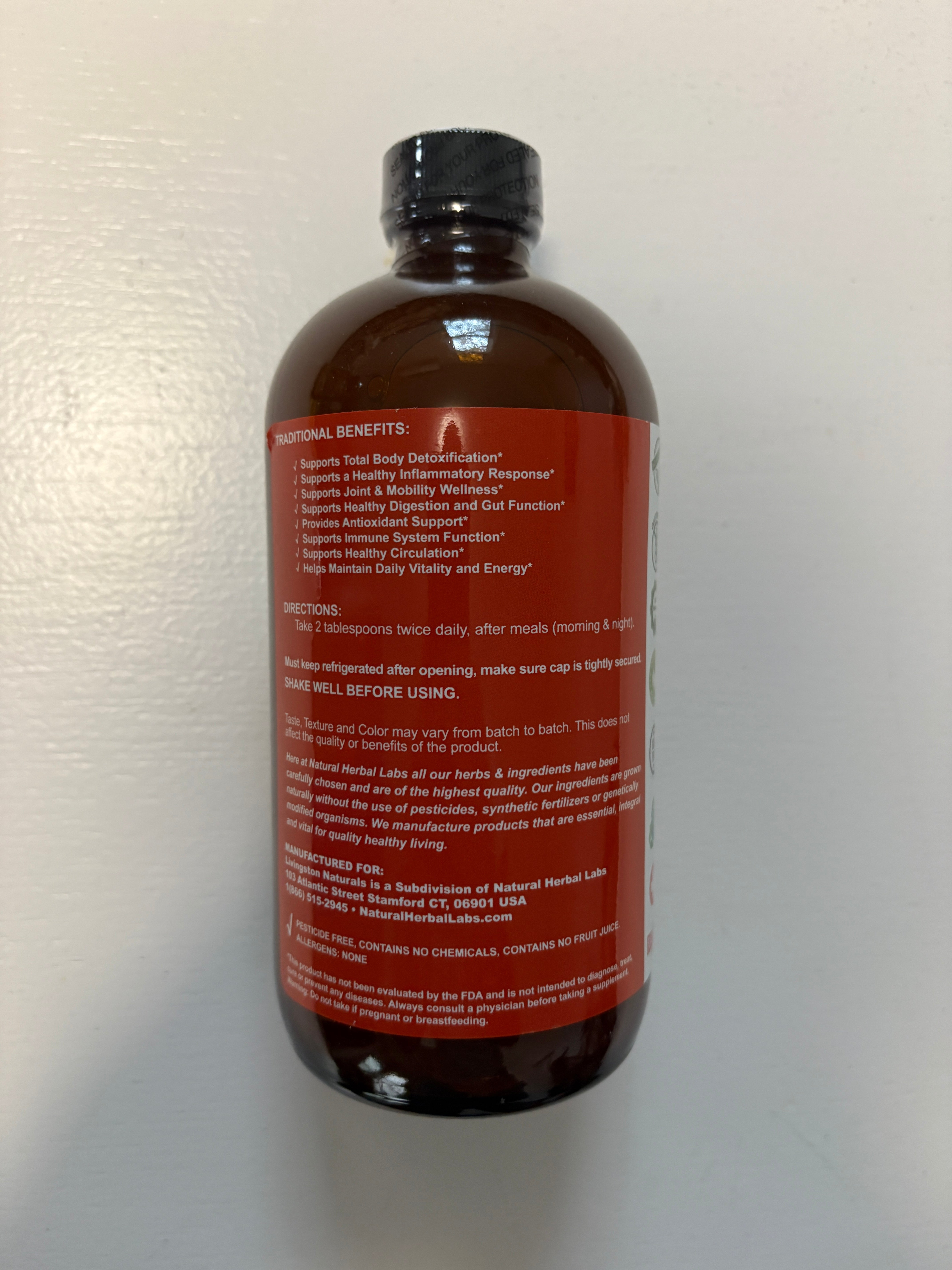 Vegan supplement bottle of VeggieVerve Organic Soursop Turmeric Bitters with fresh herbs and ingredients on a white background.