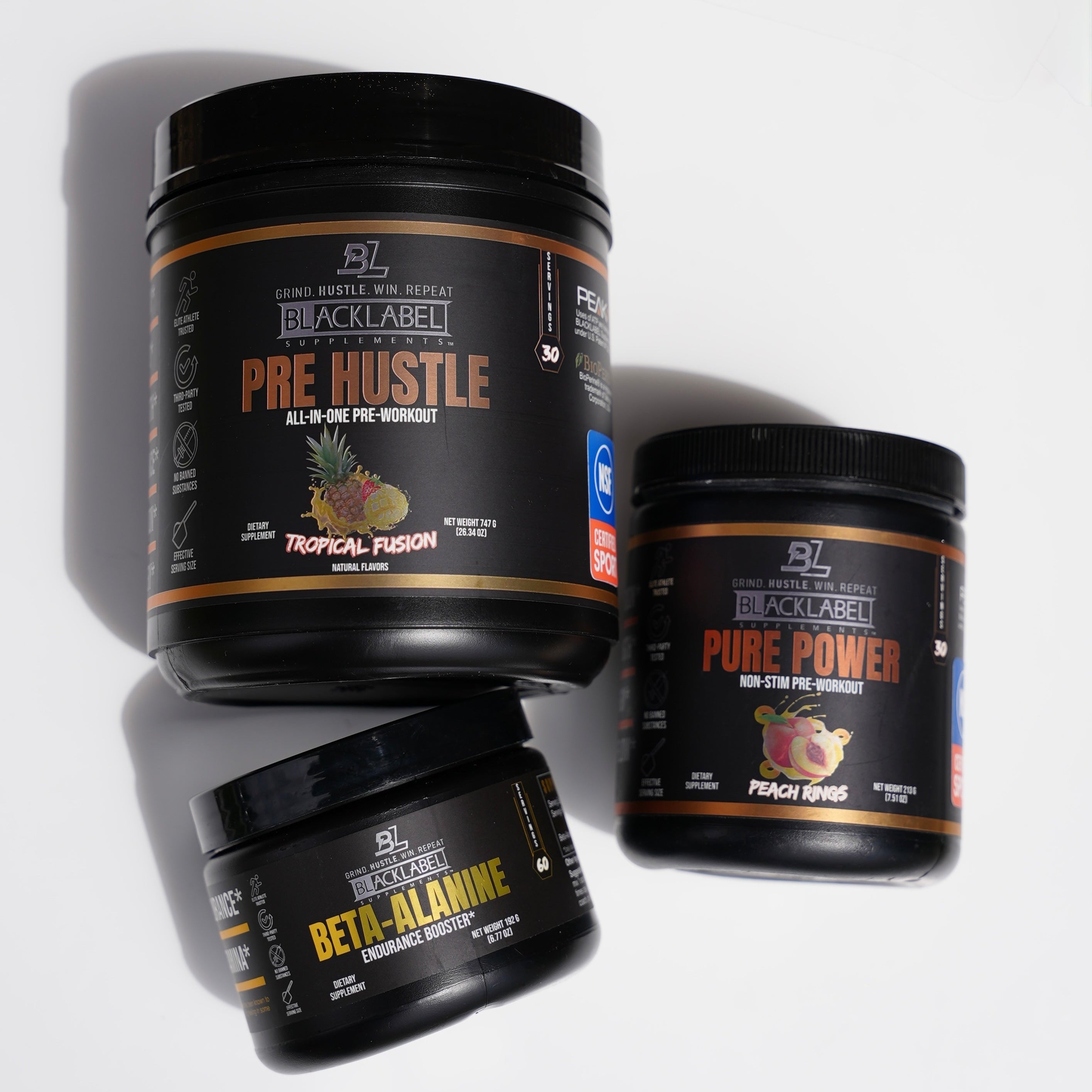 BlackLabel Supplements Performance Stack with Pre Hustle, Pure Power, and Beta-Alanine jars, black containers with orange and yellow labels.