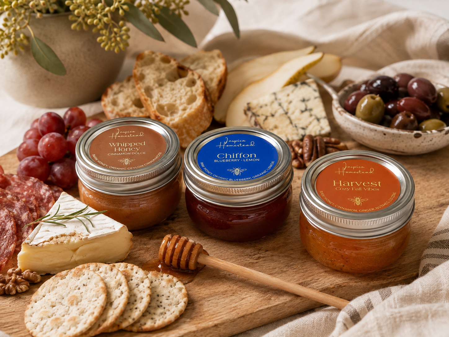 Inspira Homestead Southern Honey gift set with jars of honey arranged on a cheese board for presentation.