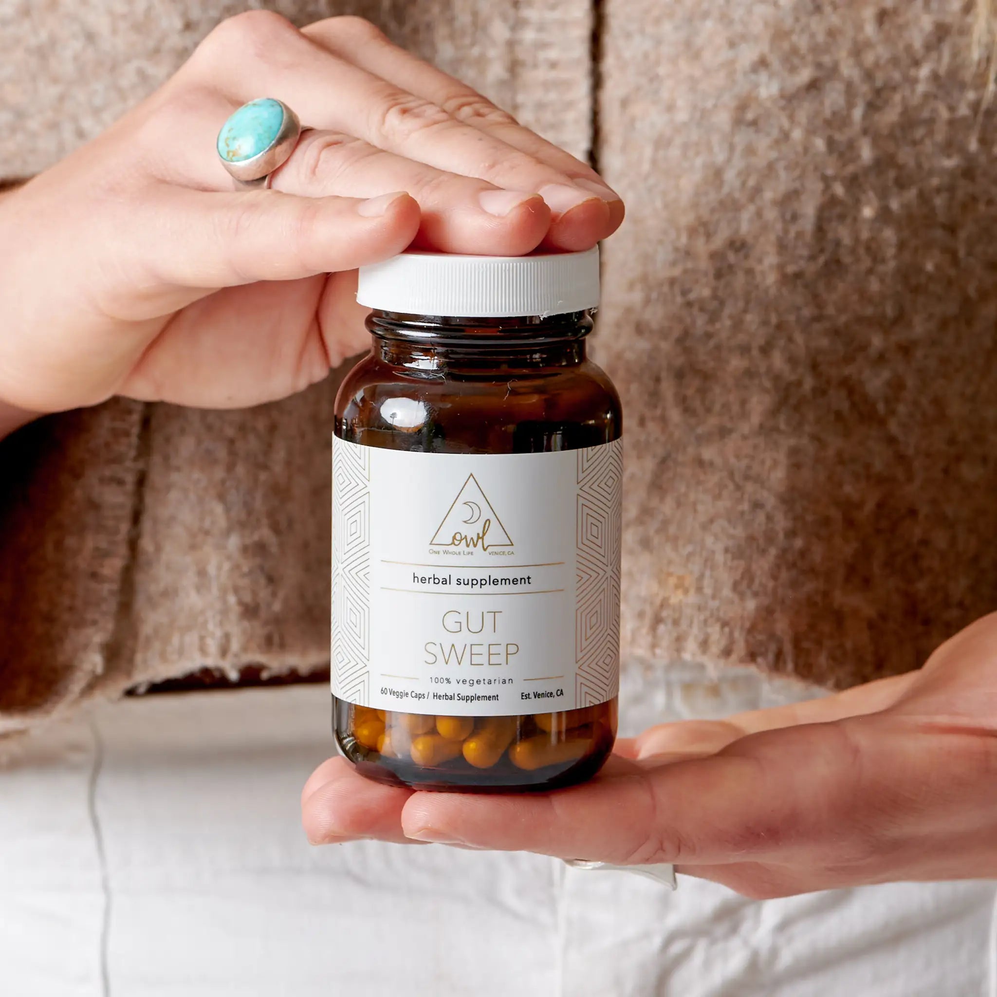 Herbal digestive wellness capsules by OWL Venice with aloe vera, marshmallow root, and slippery elm in a clear bottle.