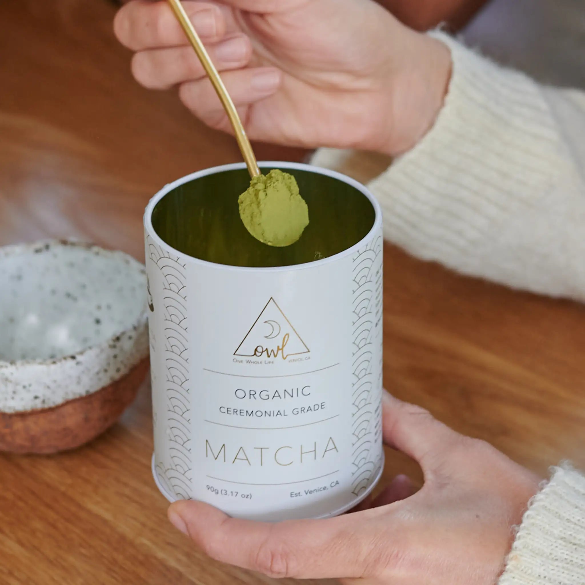 Organic Matcha powder by OWL Venice, vibrant green tea powder in a traditional canister, perfect for tea and recipes.