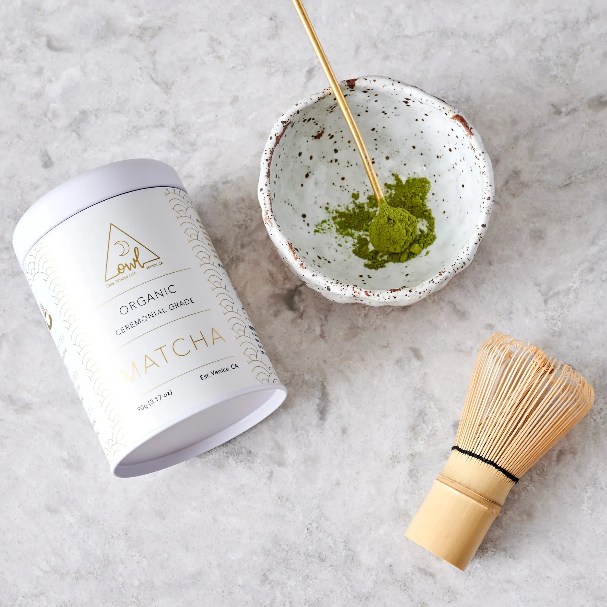 Organic Matcha Powder by OWL Venice in a green tin, finely ground vibrant green tea powder for traditional Japanese tea preparation.