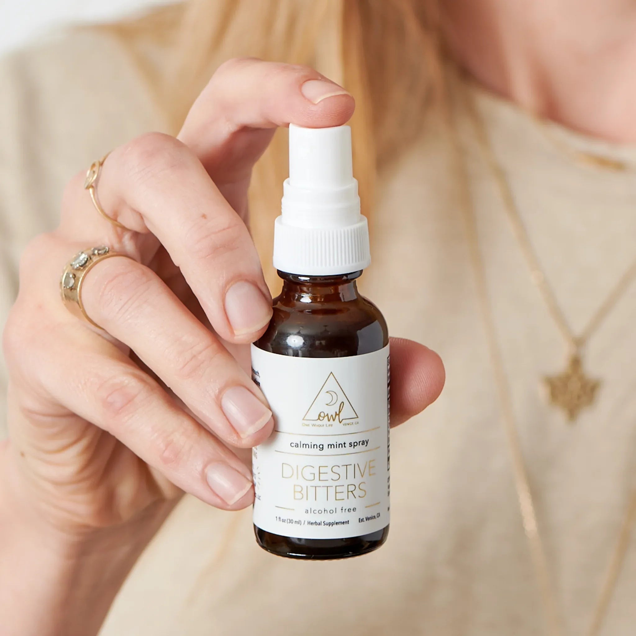 Bottle of OWL Venice Digestive Bitters supplement with herbal ingredients in a clear glass container on a neutral background.
