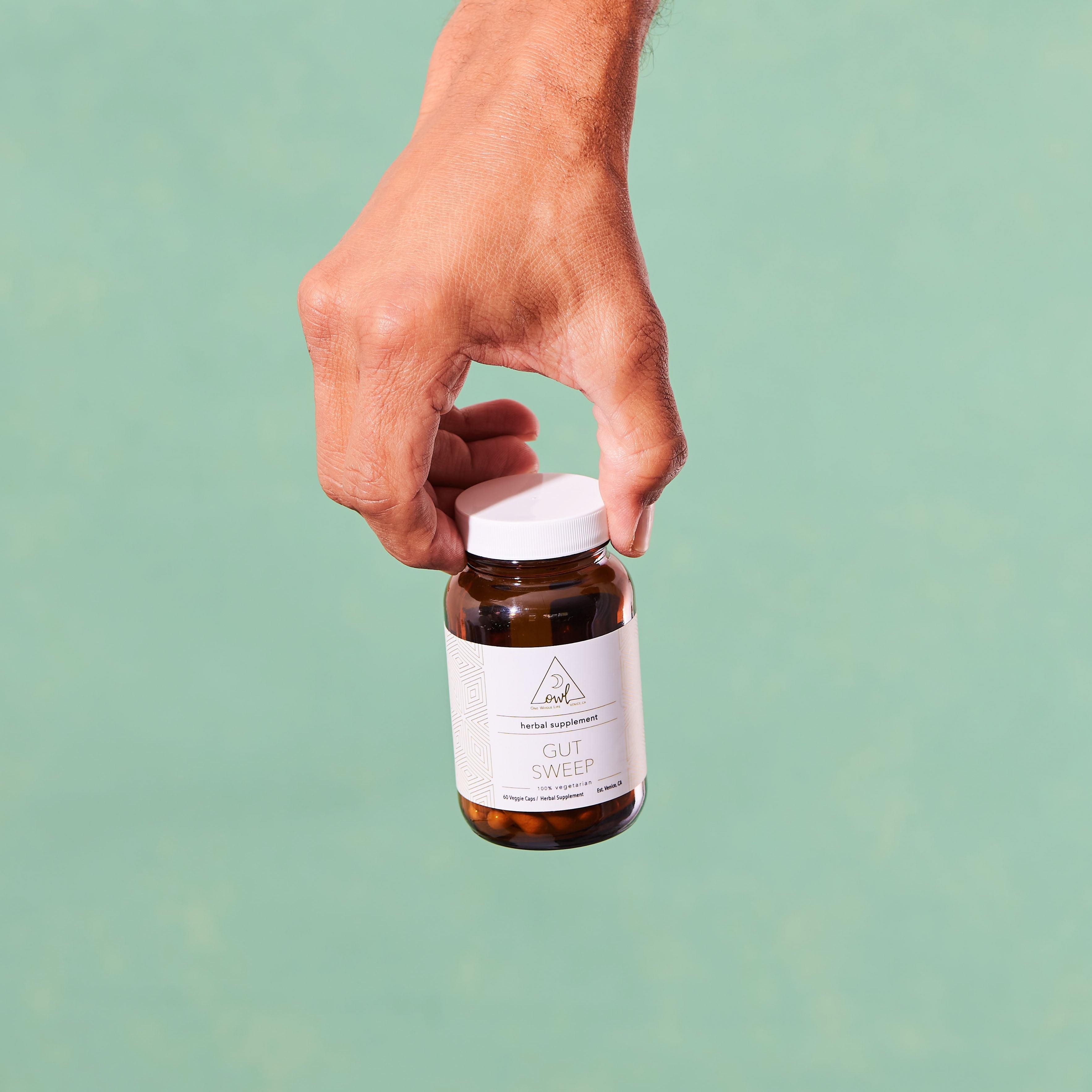 OWL Venice Gut Sweep herbal digestive wellness capsules with aloe vera, marshmallow root, and slippery elm, displayed in a bottle.