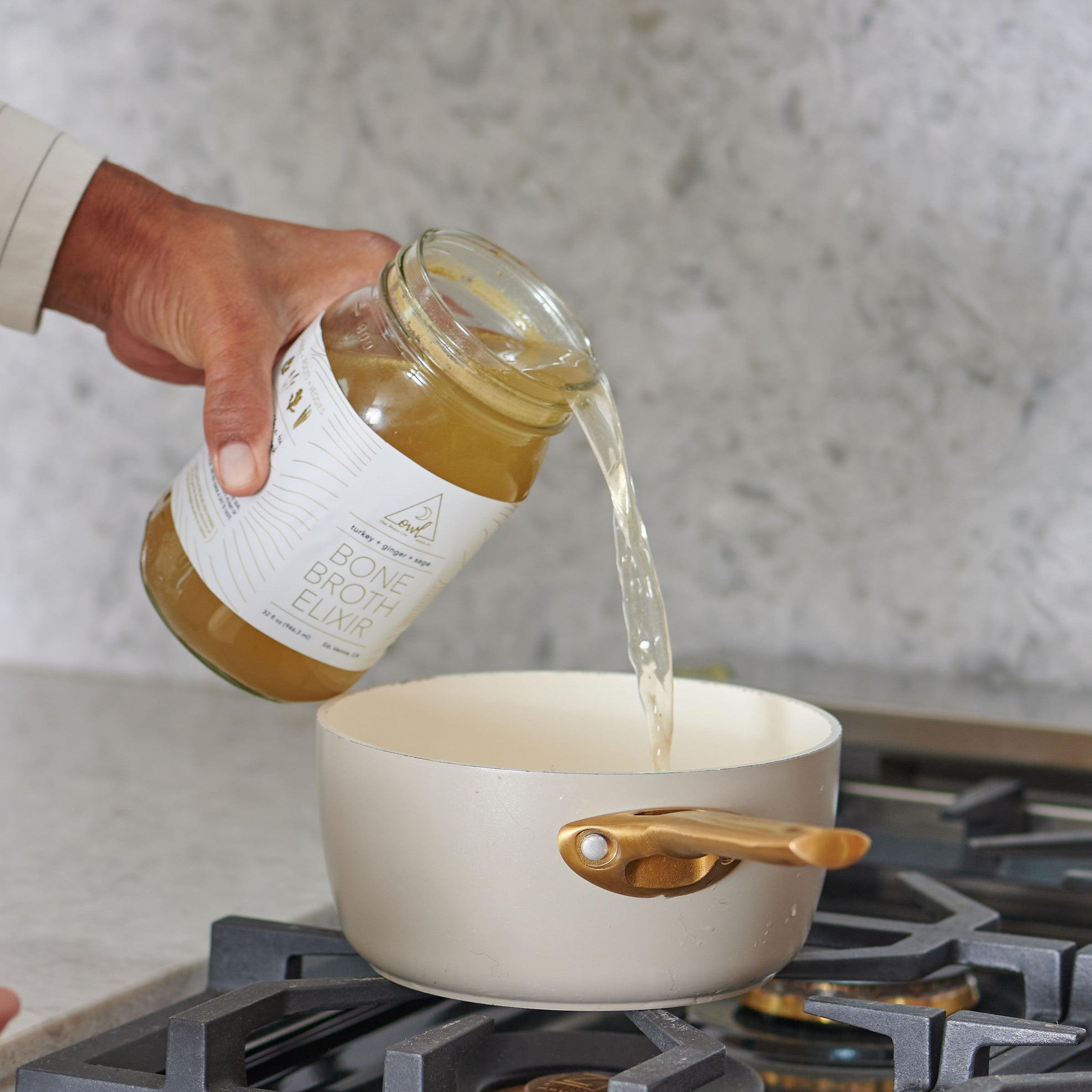 A jar of OWL Venice organic bone broth from the 30 Day Broth Challenge, showcasing the product label and glass jar.