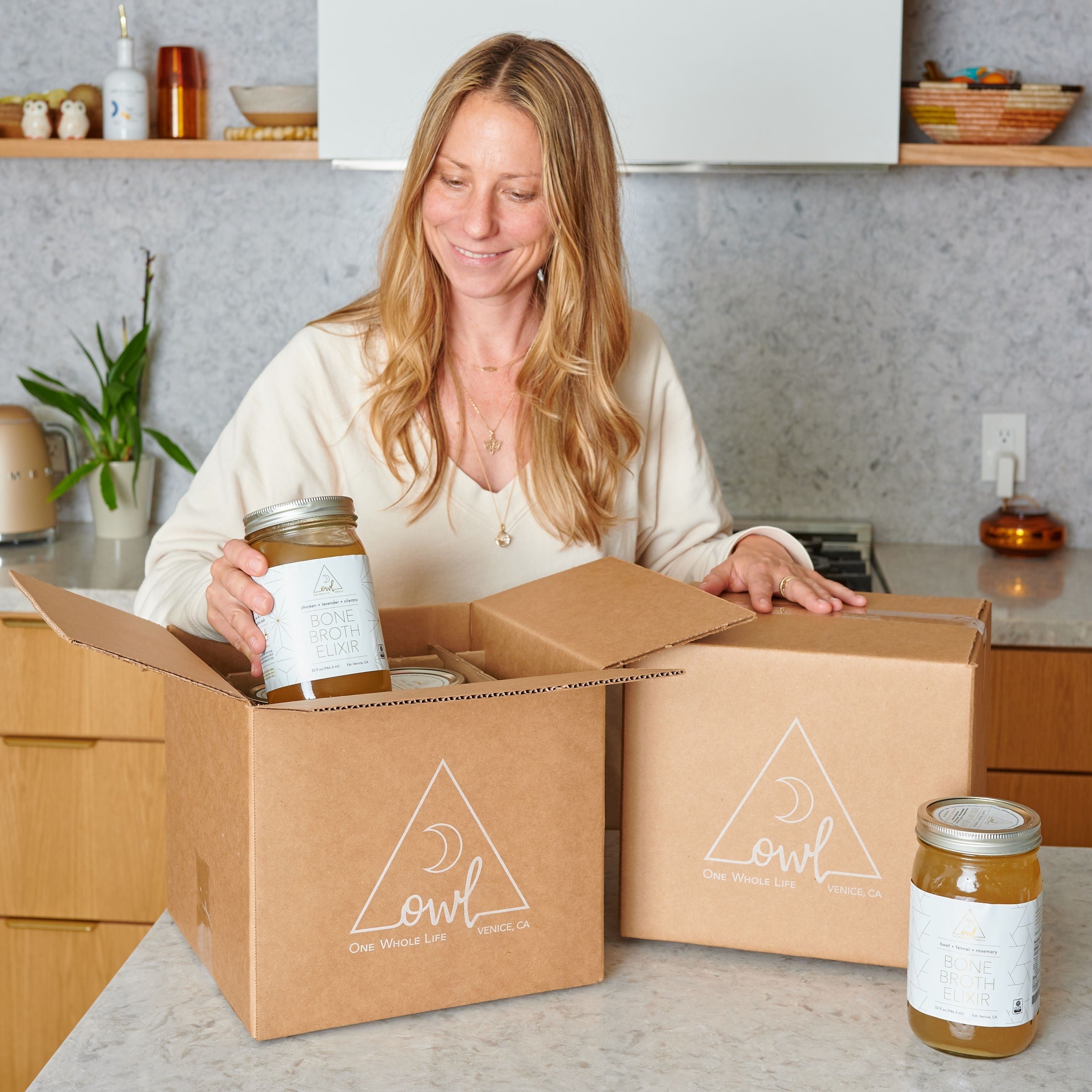A jar of OWL Venice Organic Bone Broth from the 30 Day Broth Challenge, featuring a clear label and rich broth inside.