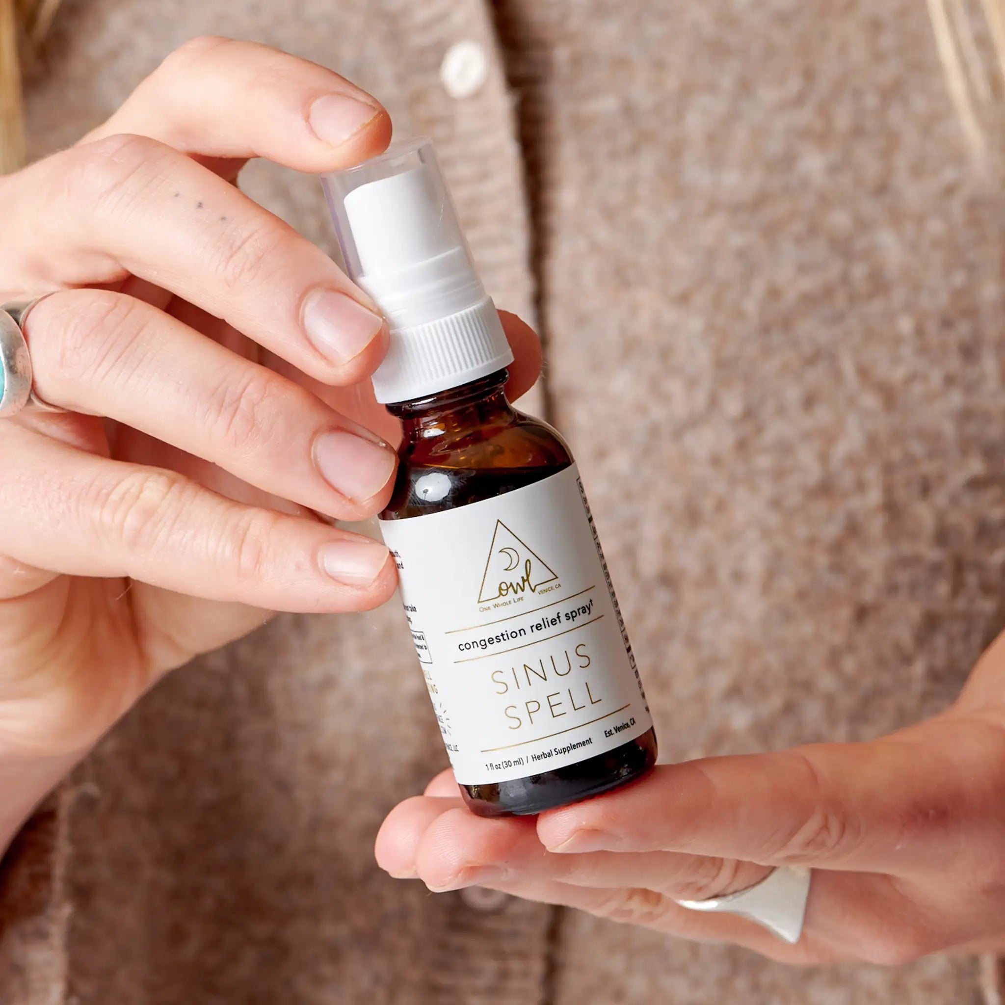 Bottle of OWL Venice Sinus Spell supplement with label visible, designed to support sinus health and respiratory relief.