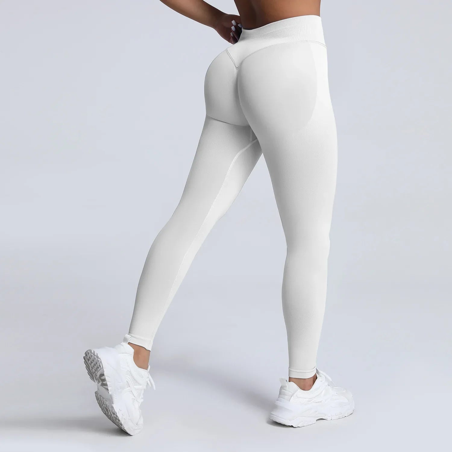 Women's low waist scrunch bum yoga leggings by THRIXINE, close-up of black high-stretch fabric with scrunch detail at the back