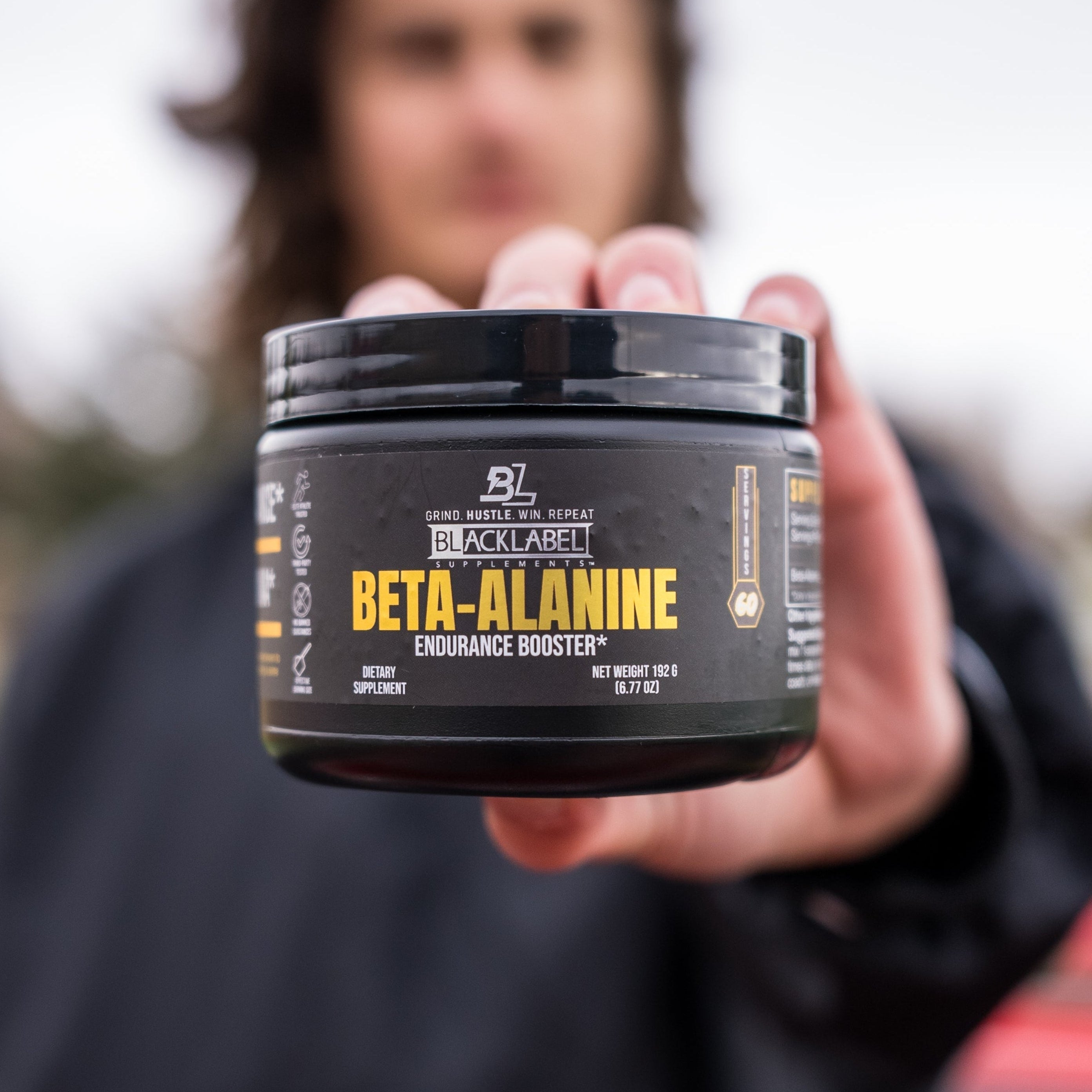 BlackLabel Supplements Beta-Alanine powder in a clear container, with scoops and label visible on a white background.