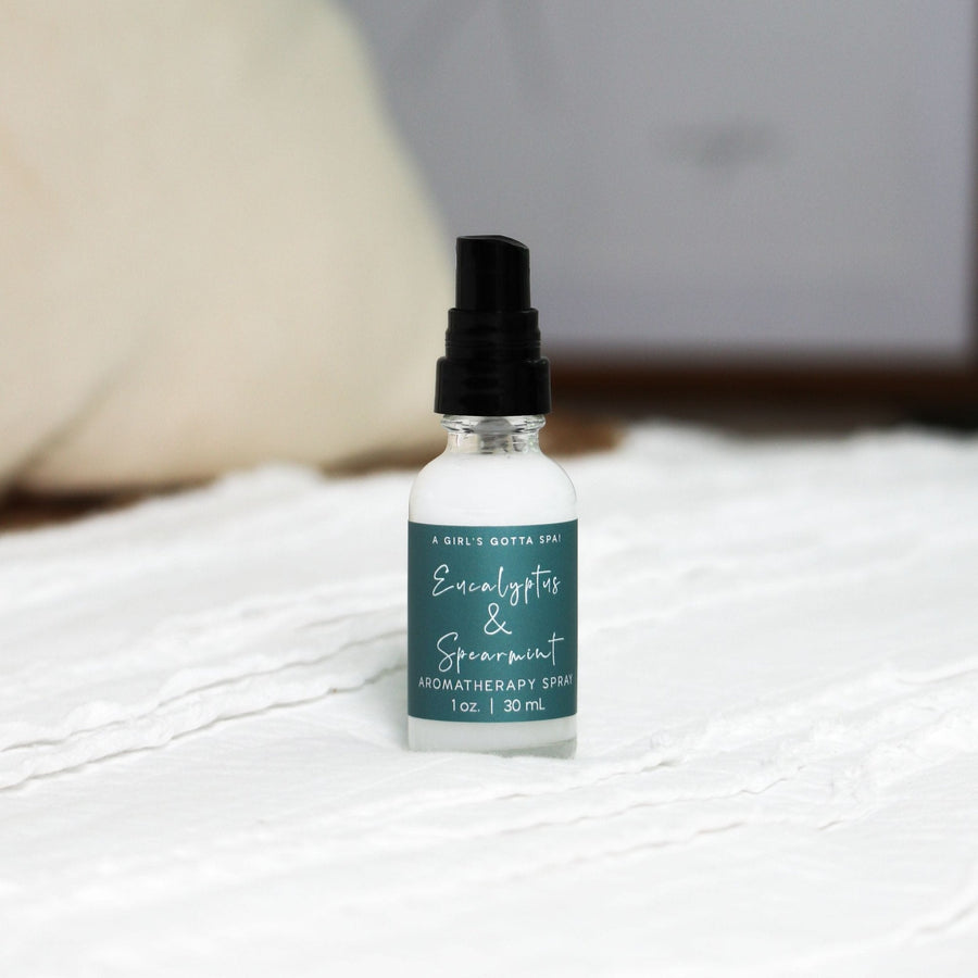 Eucalyptus and spearmint aromatherapy spray by A Girl's Gotta Spa! in a clear glass spray bottle with a white cap.