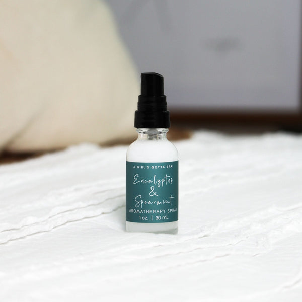 Eucalyptus and spearmint aromatherapy spray by A Girl's Gotta Spa! in a clear glass spray bottle with a white cap.
