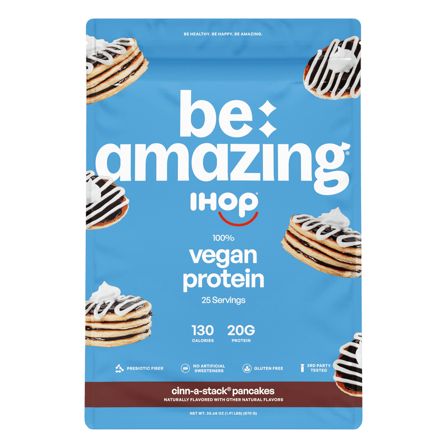 Be Amazing vegan protein powder with pineapple flavor, showing the container and serving scoop on a white background.
