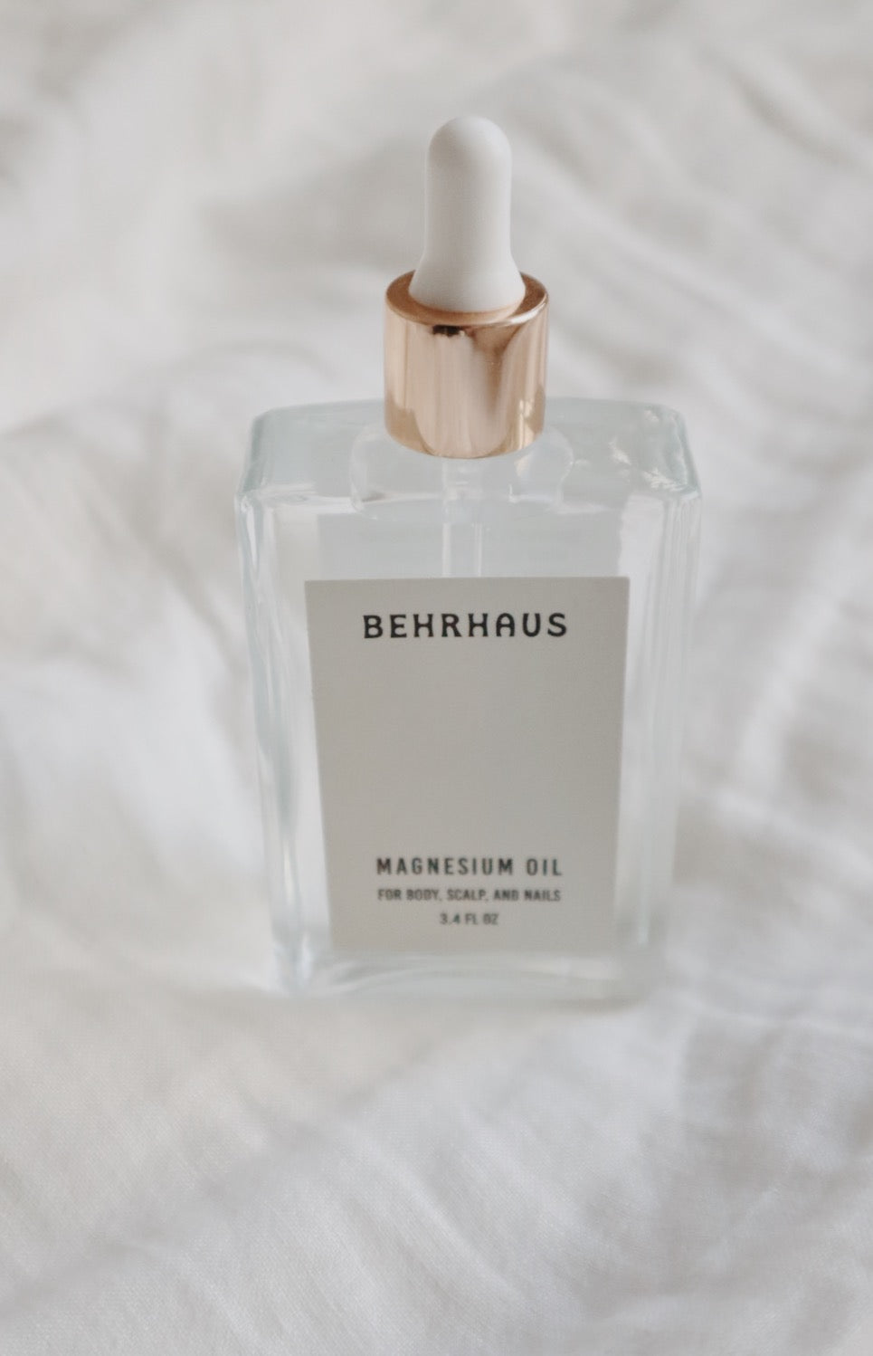 Behrhaus magnesium body oil in a 3.4 oz bottle, moisturizing and soothing skin with natural magnesium oil for relaxation and relief.