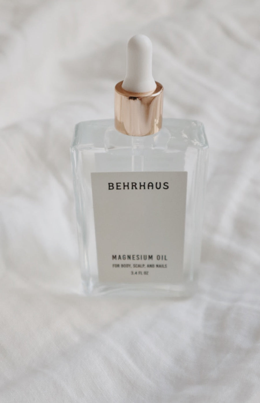 Behrhaus magnesium body oil in a 3.4 oz bottle, moisturizing and soothing skin with natural magnesium oil for relaxation and relief.