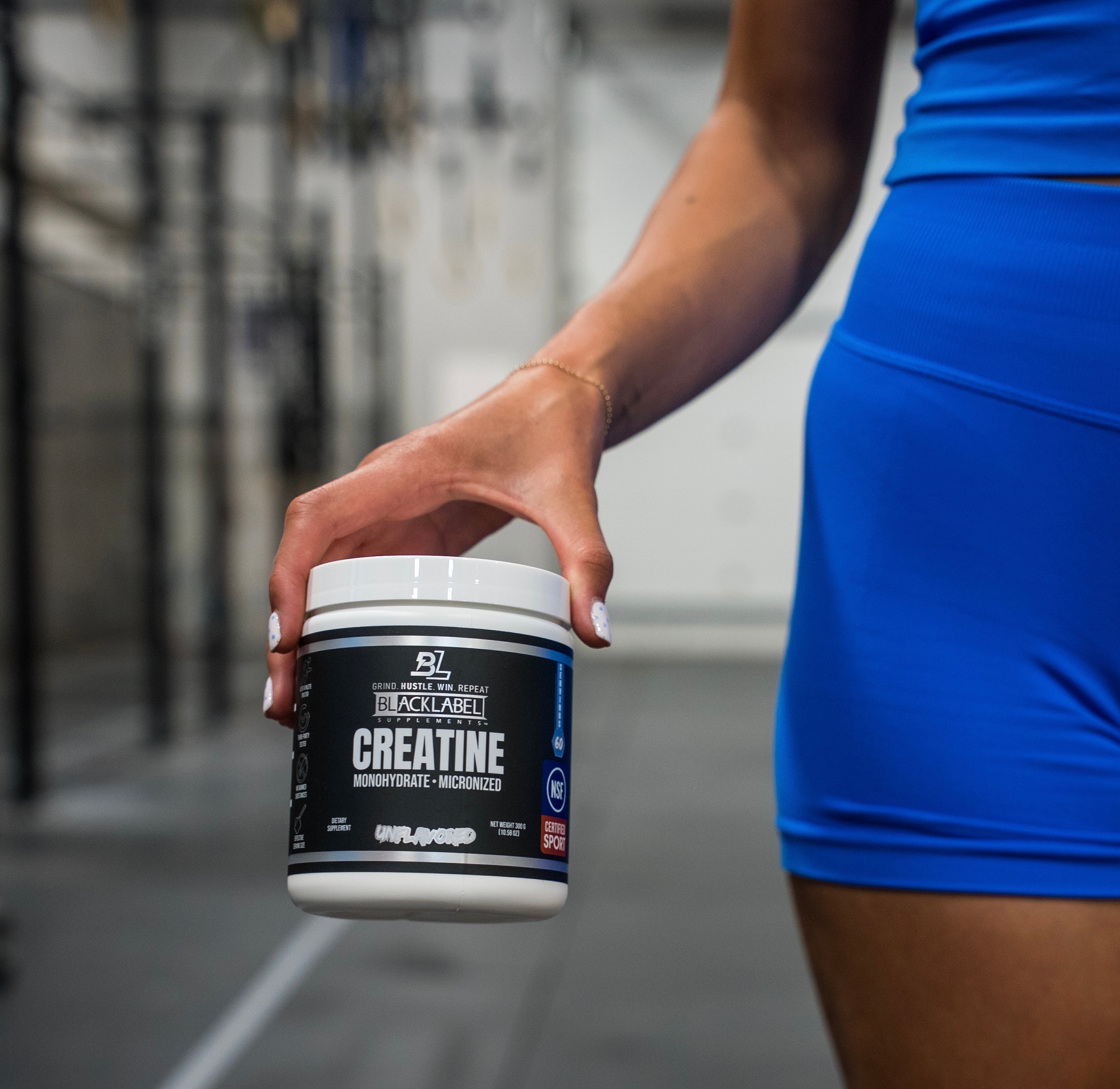 BlackLabel Supplements creatine monohydrate powder in a clear container, showing white powder inside for muscle support.