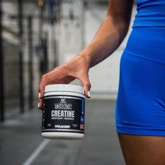 BlackLabel Supplements creatine monohydrate powder in a clear container, showing white powder inside for muscle support.