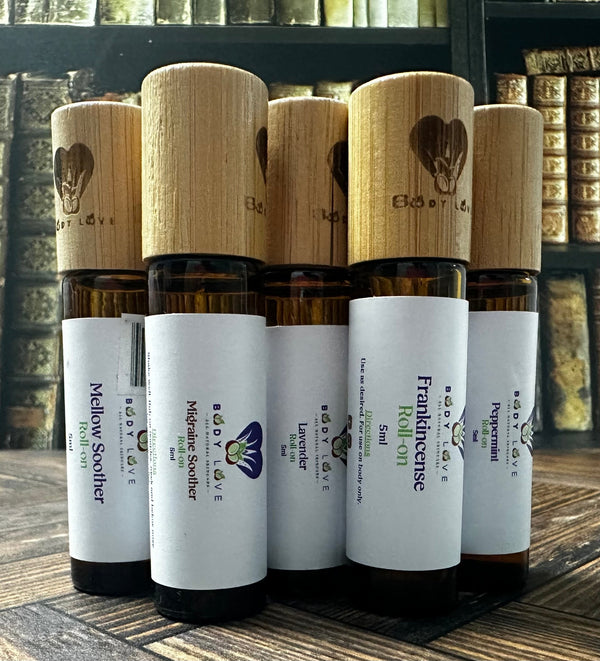 Body Love Self Care essential oil travelers roll-ons, portable diffuser oils in sleek bottles for on-the-go aromatherapy.