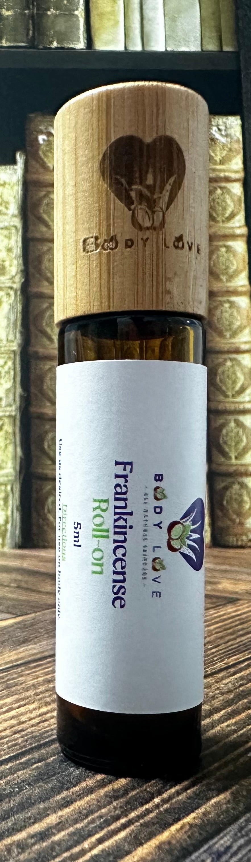 Body Love Self Care essential diffuser oils in travel-sized roll-ons, including Bandit's Brew scent, displayed in a close-up image.