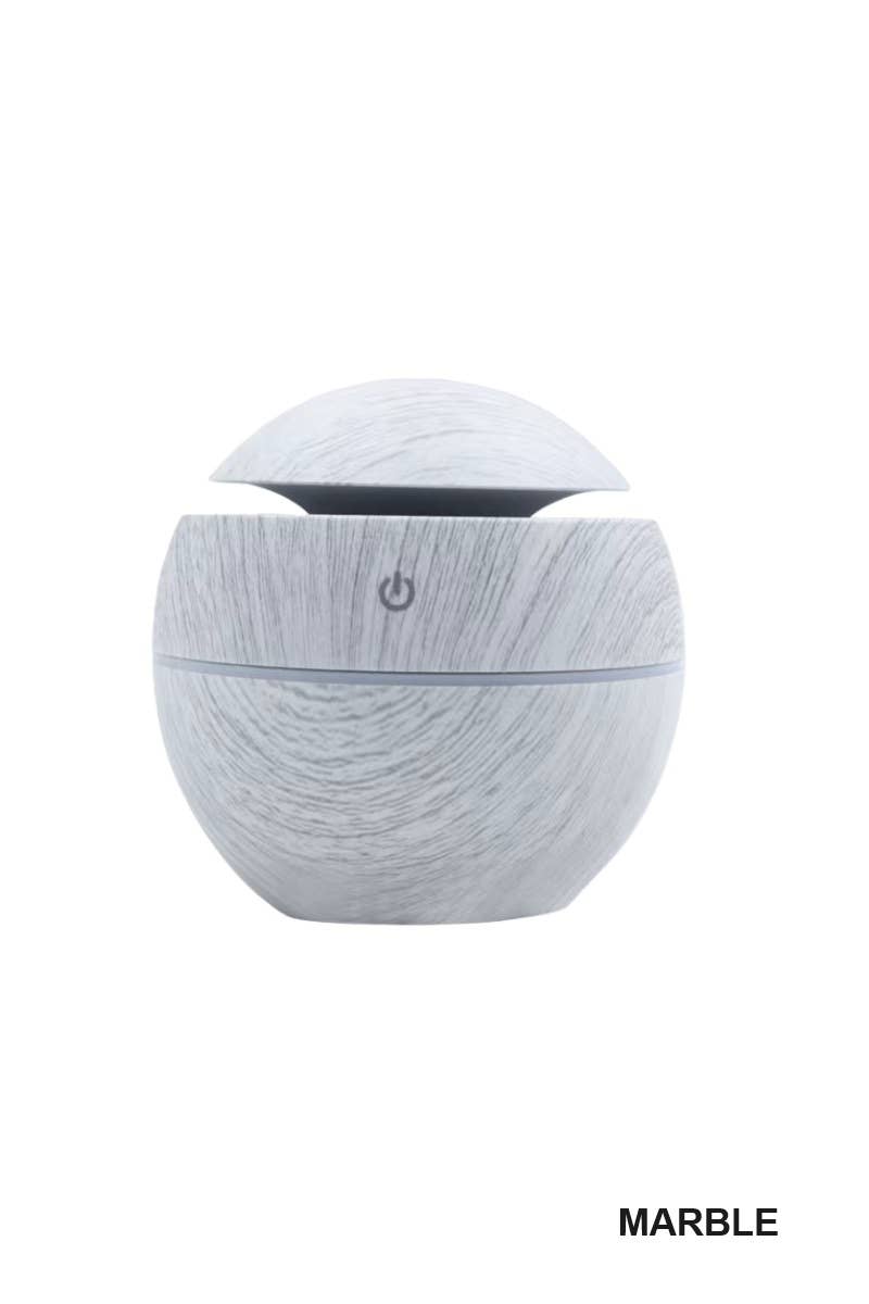 BioWizdom TikTok ultrasonic humidifier and aroma diffuser showing a sleek white device emitting mist on a bedside table.