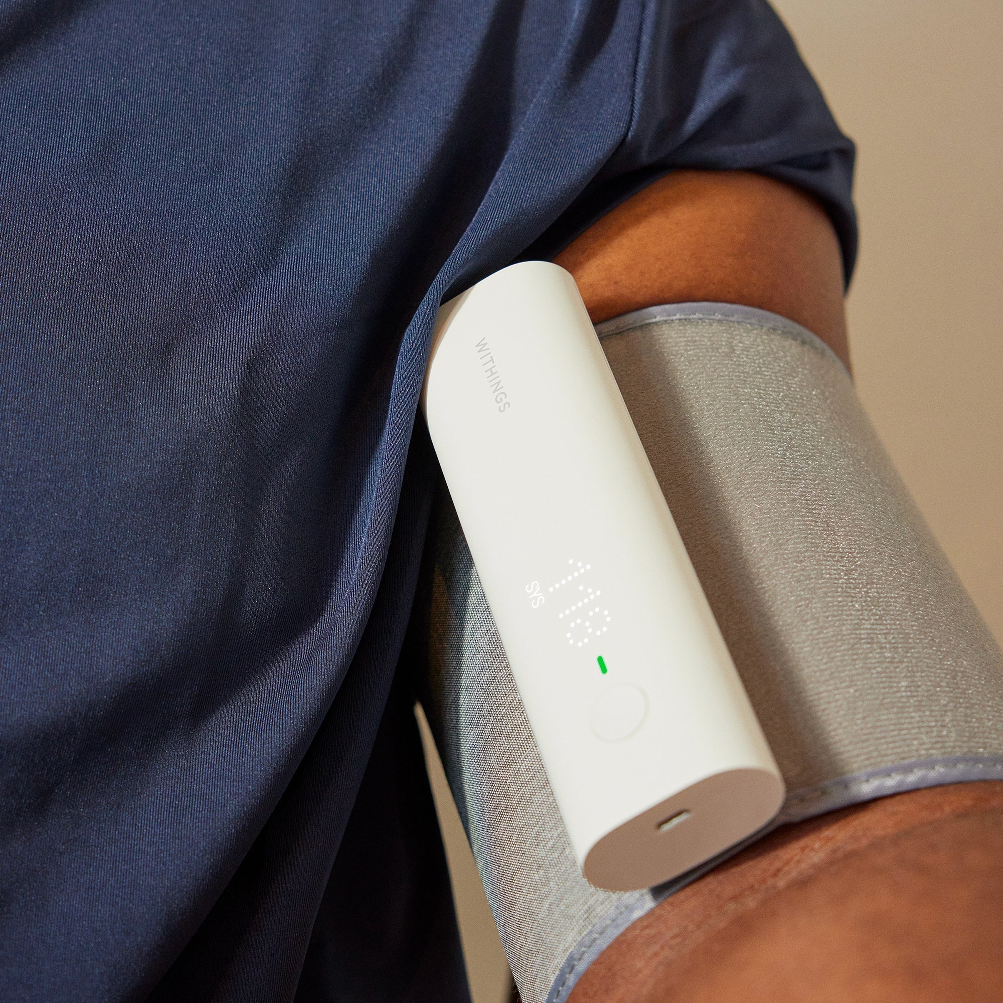Medisitis Withings wireless upper arm blood pressure monitor displaying a digital screen with blood pressure readings.