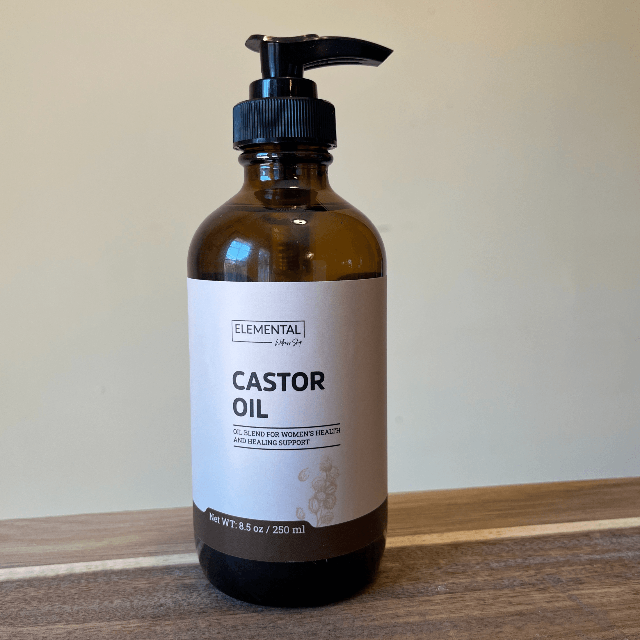 Organic hexane-free castor oil from Elemental Wellness Shop in a clear glass bottle, suitable for hair, skin, and castor oil packs.