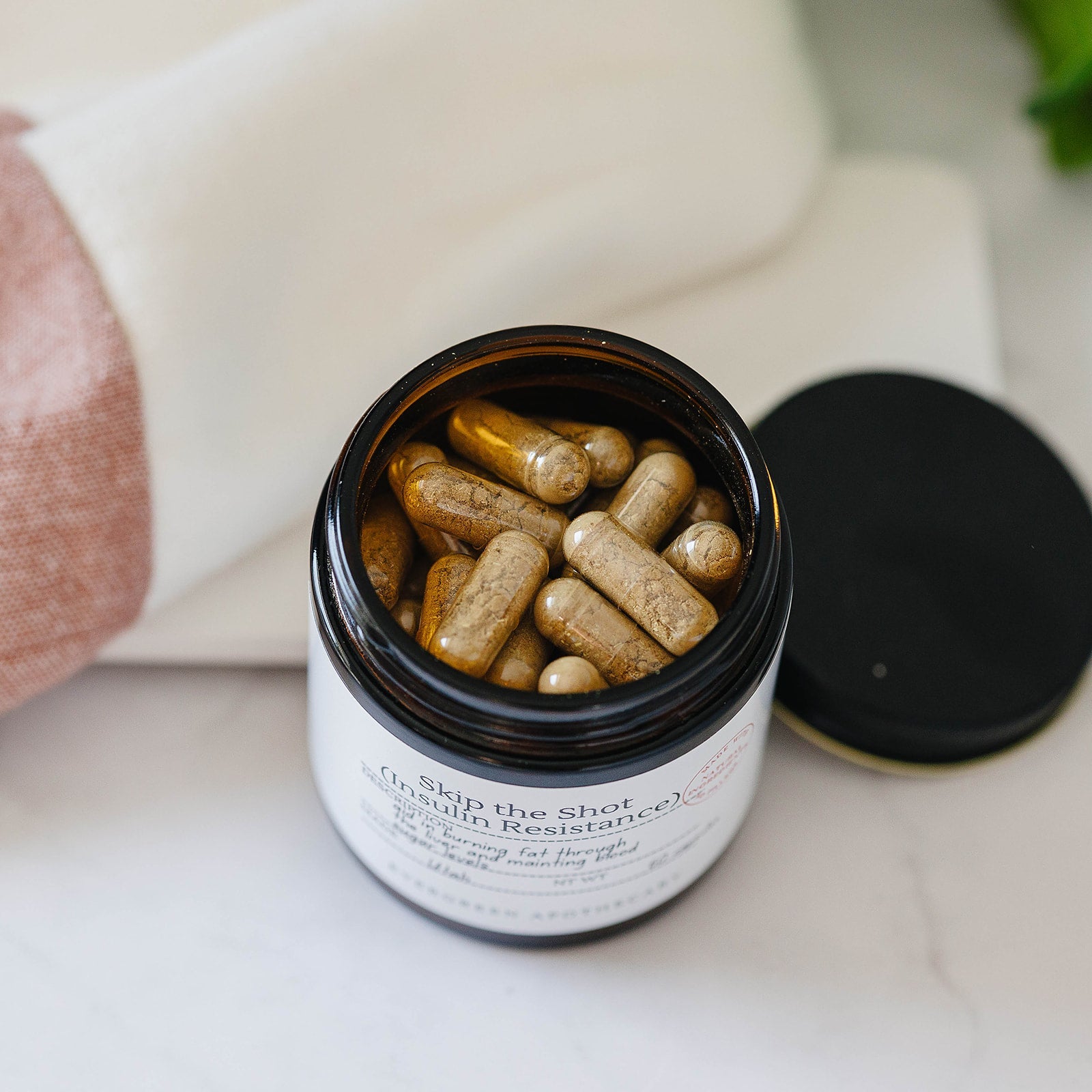 Evergreen Apothecary Botanical Wellness Capsules featuring a herbal blend formula in a clear capsule.
