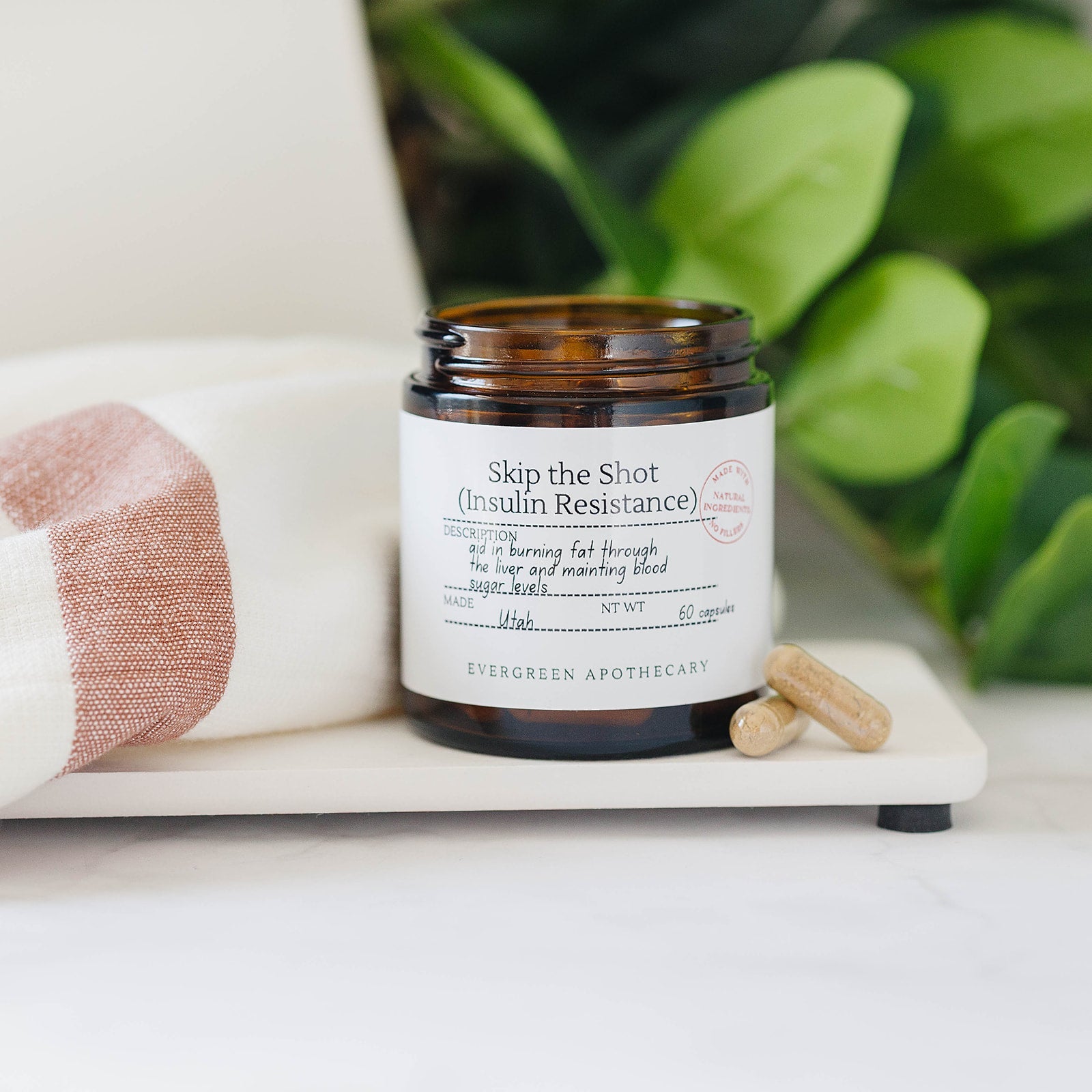 Evergreen Apothecary Botanical Wellness Capsules with herbal blend, showing capsules in a clear container, natural and herbal health supplement.