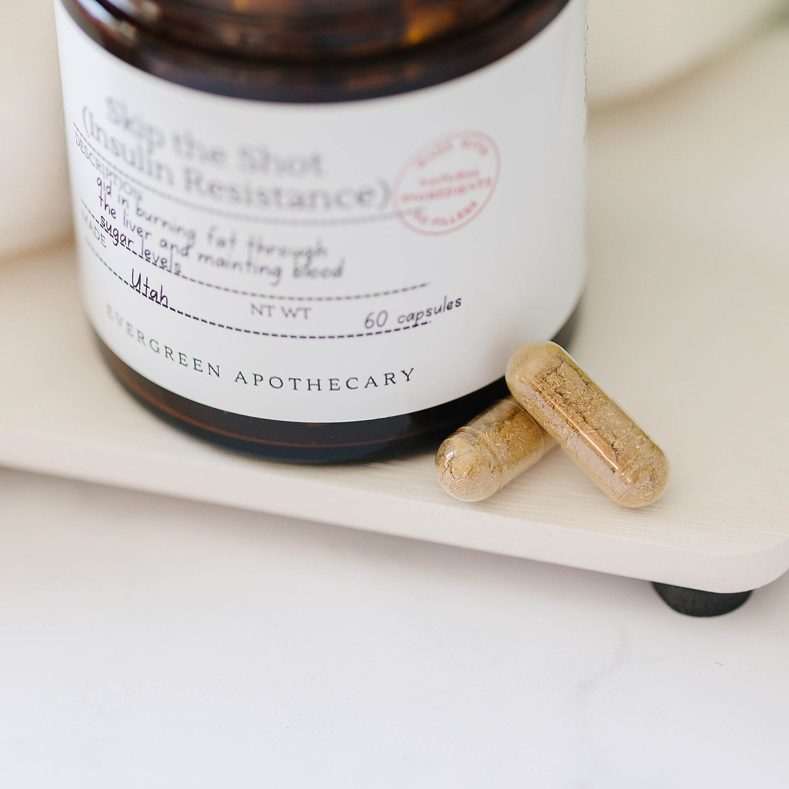 Evergreen Apothecary Botanical Wellness Capsules with herbal blend formula, showing a close-up of the capsule bottle and capsules inside