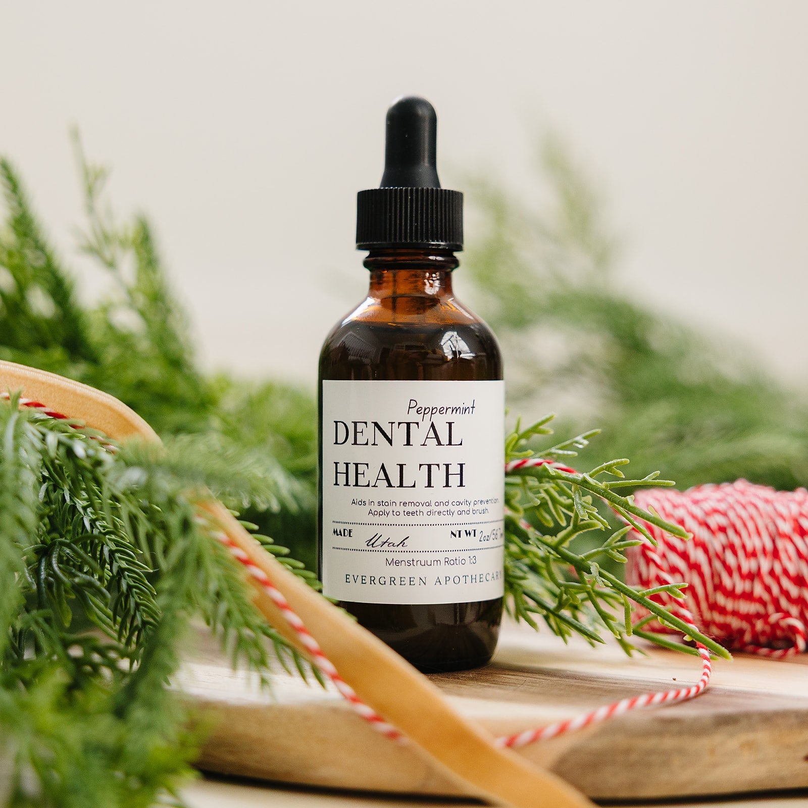 Evergreen Apothecary Dental Health Oil Brushing peppermint oral supplement bottle with label and dropper for oral care.