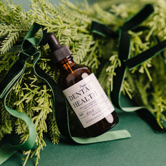 Evergreen Apothecary dental health oil brushing supplement with peppermint flavor, featuring a bottle with a dropper applicator.