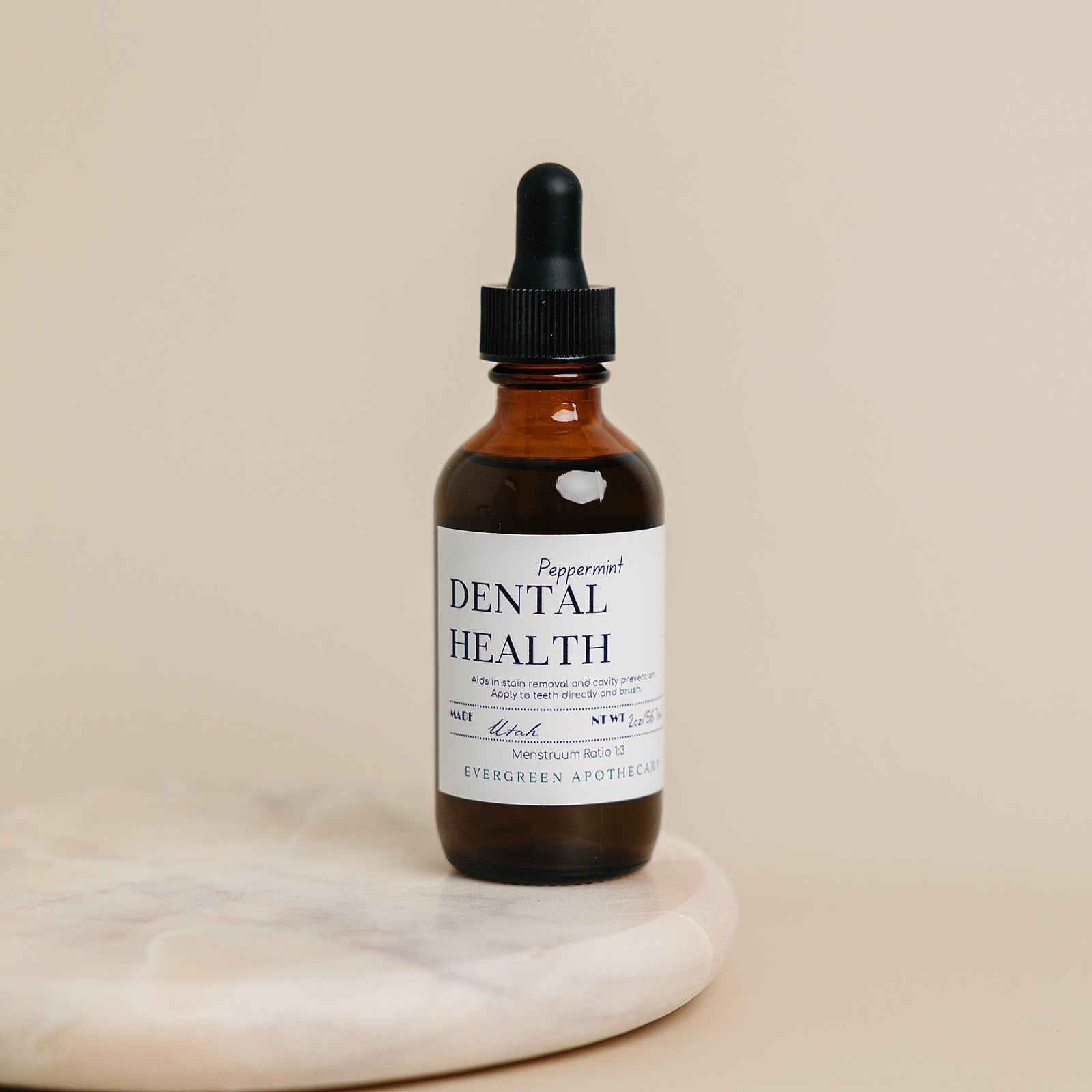Evergreen Apothecary dental health oil brushing supplement with peppermint flavor, shown in a clear bottle with a white cap.