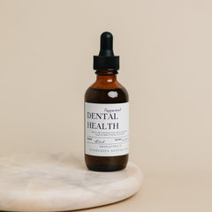 Evergreen Apothecary dental health oil brushing supplement with peppermint flavor, shown in a clear bottle with a white cap.