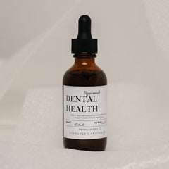Evergreen Apothecary Dental Health Oil Brushing supplement with peppermint flavor, showing the bottle, label, and fresh mint leaves.